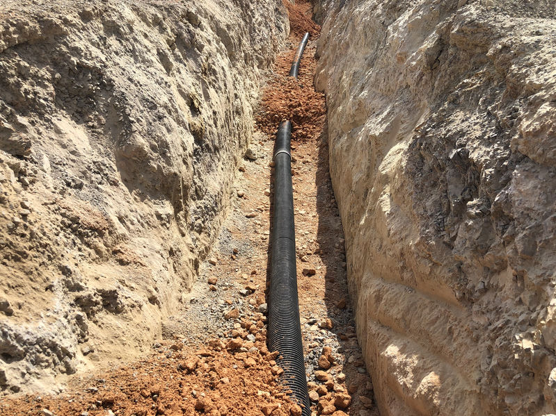 A cable laid in an underground cabling trench.