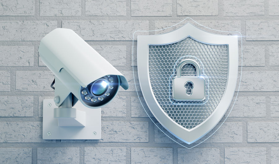 A CCTV Camera next to a shield with a lock on it, symbolizing security