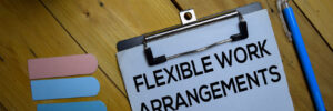 a clipboard containing a piece of paper that says "flexible work arrangements"